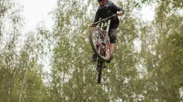 a man riding a bike up in the air