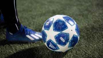 blue and white soccer ball on green grass field